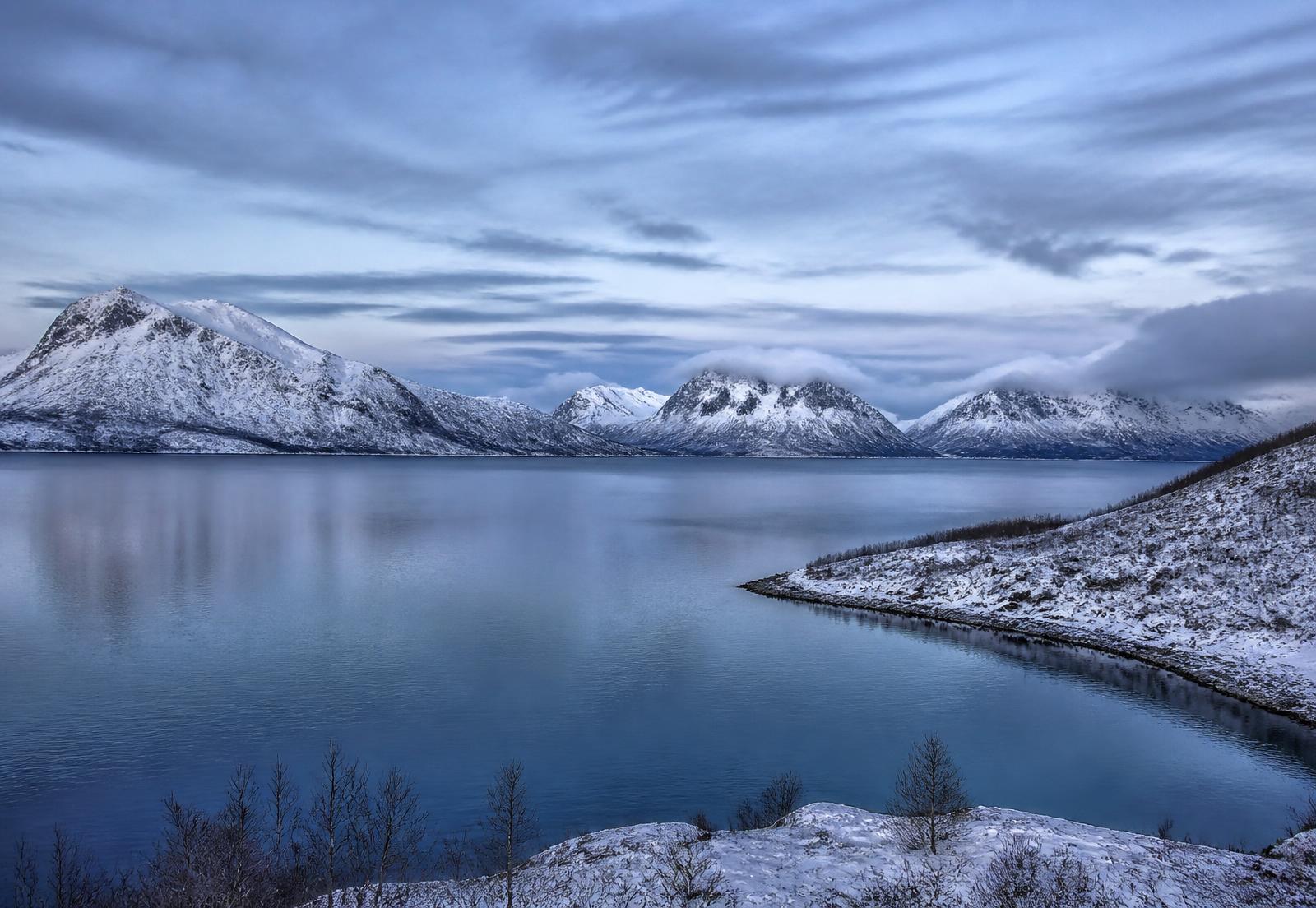 Snow-covered fjord landscape near Tromsø in winter light